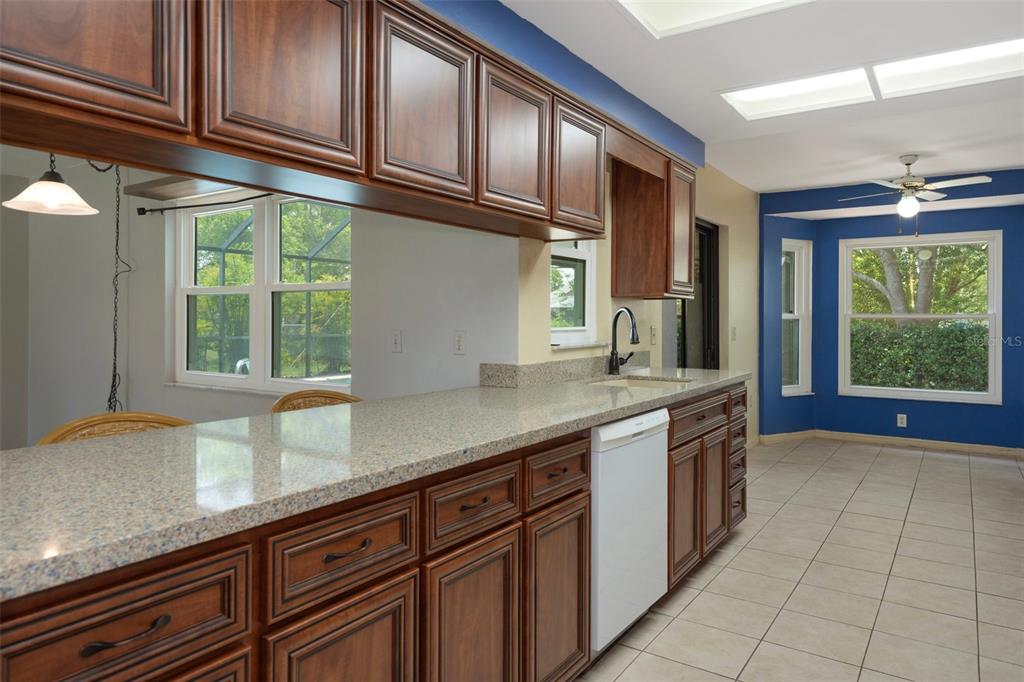 8332 Berkeley Manor Boulevard Spring Hill, FL 34606 - Photo 6 of 45 a kitchen with stainless steel appliances granite countertop a sink a window and cabinets