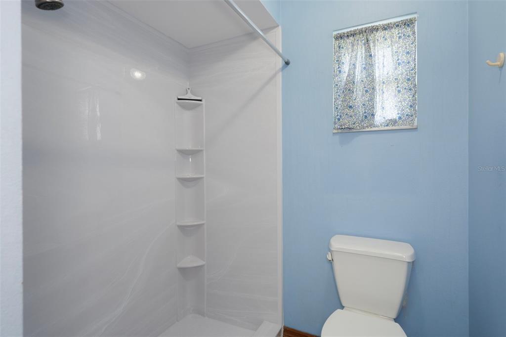 8332 Berkeley Manor Boulevard Spring Hill, FL 34606 - Photo 7 of 45 a bathroom with a toilet sink and mirror