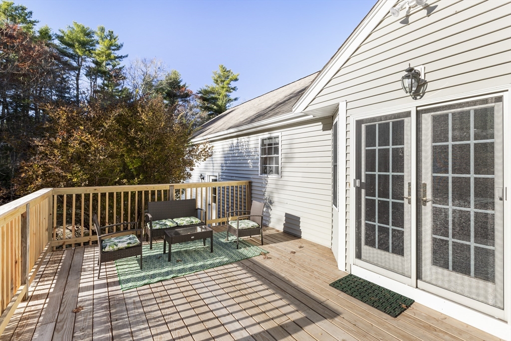 460 High Street Rochester, MA 02770 - Photo 25 of 31 a view of a deck with couches table and chairs and potted plants