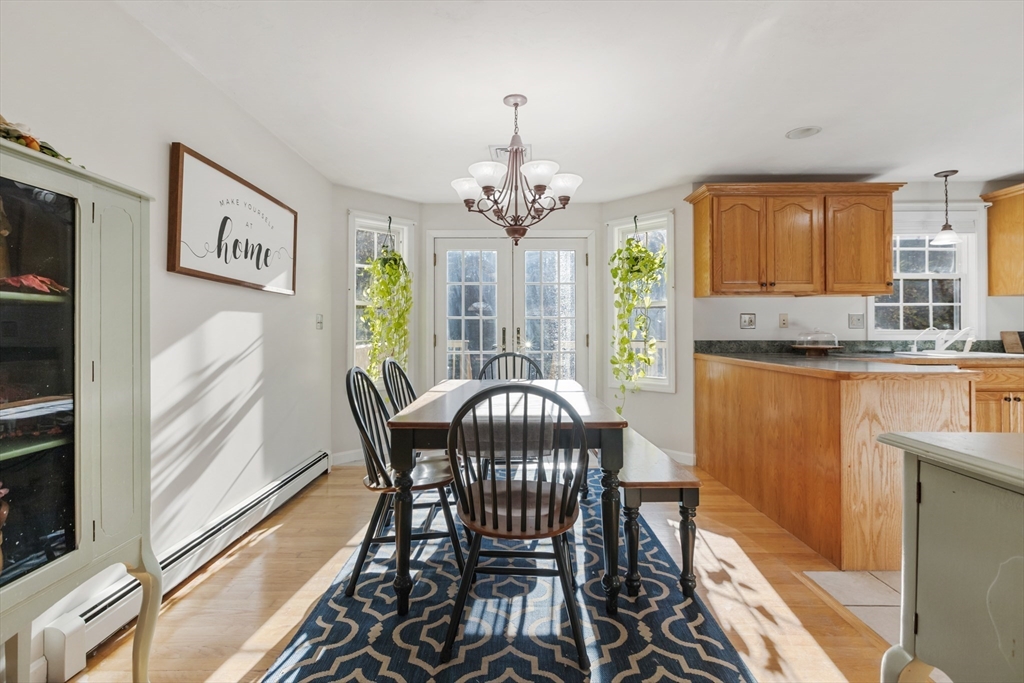 460 High Street Rochester, MA 02770 - Photo 8 of 31 a view of a dining room with furniture a chandelier and wooden floor