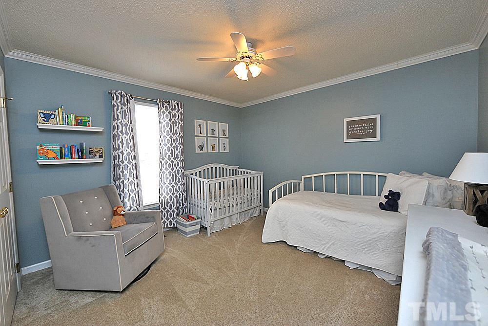 2804 Livery Way Raleigh, NC 27603 - Photo 14 of 24 a bedroom with two beds and a chandelier
