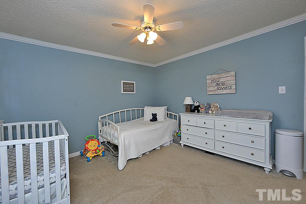 2804 Livery Way Raleigh, NC 27603 - Photo 15 of 24 a bedroom with furniture and a chandelier