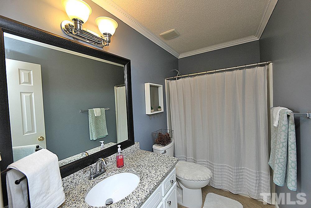 2804 Livery Way Raleigh, NC 27603 - Photo 18 of 24 a bathroom with a granite countertop sink toilet and shower