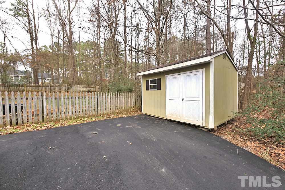2804 Livery Way Raleigh, NC 27603 - Photo 21 of 24 a view of a house with a large tree and wooden fence