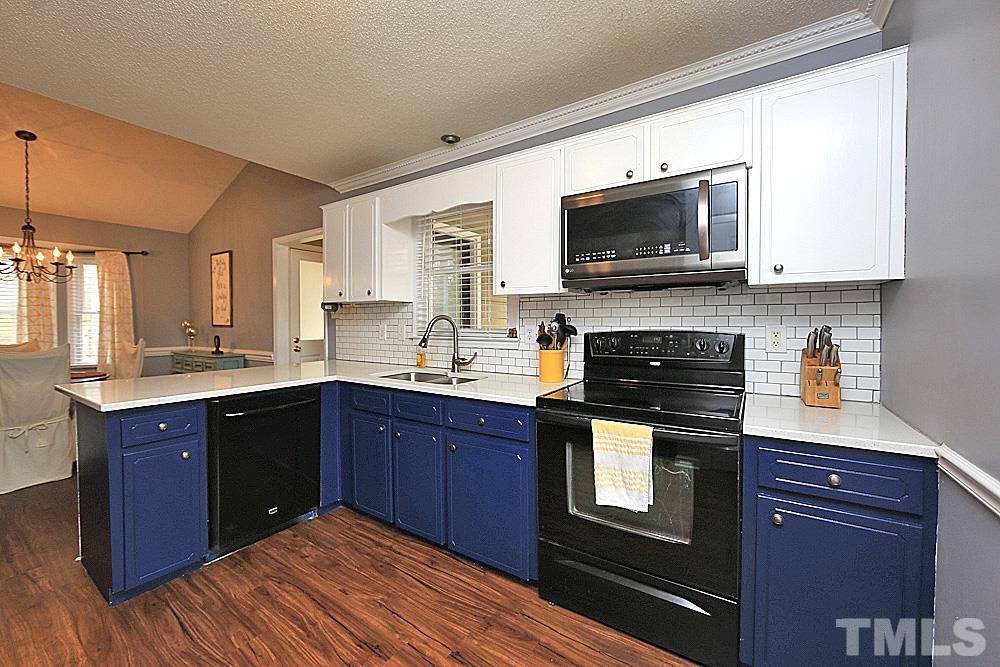 2804 Livery Way Raleigh, NC 27603 - Photo 9 of 24 a kitchen with stainless steel appliances granite countertop a stove microwave and sink