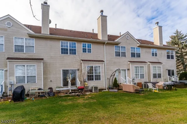 a front view of a house with a garden and yard