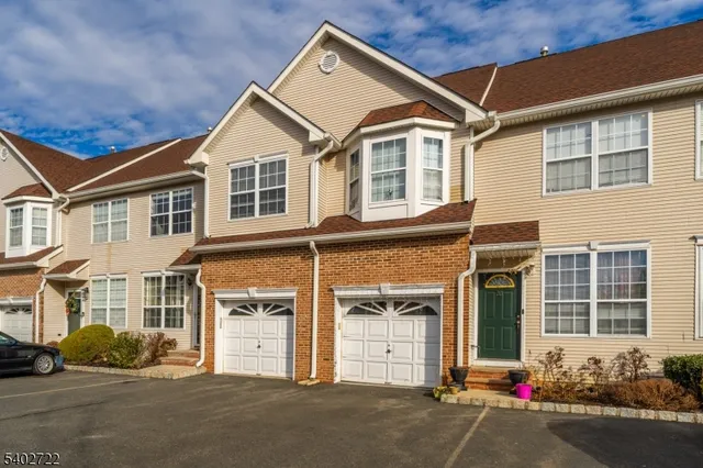 a front view of a house with a road