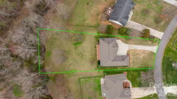 front view of a brick house with a yard