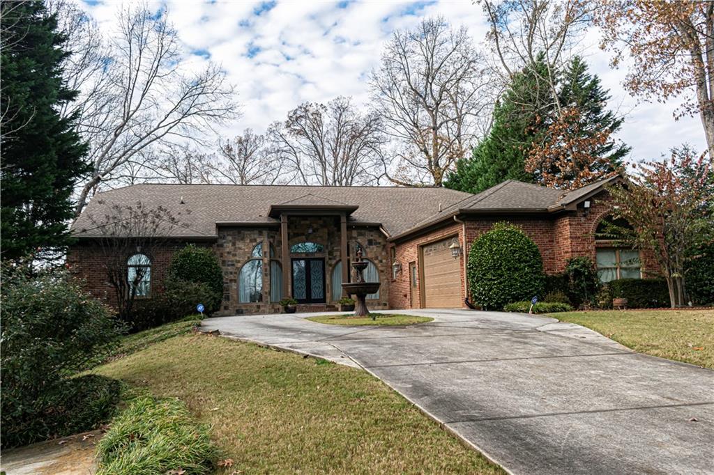2050 Oak Grove Road Northeast Atlanta, GA 30345 - Photo 1 of 11 a front view of a building with a garden