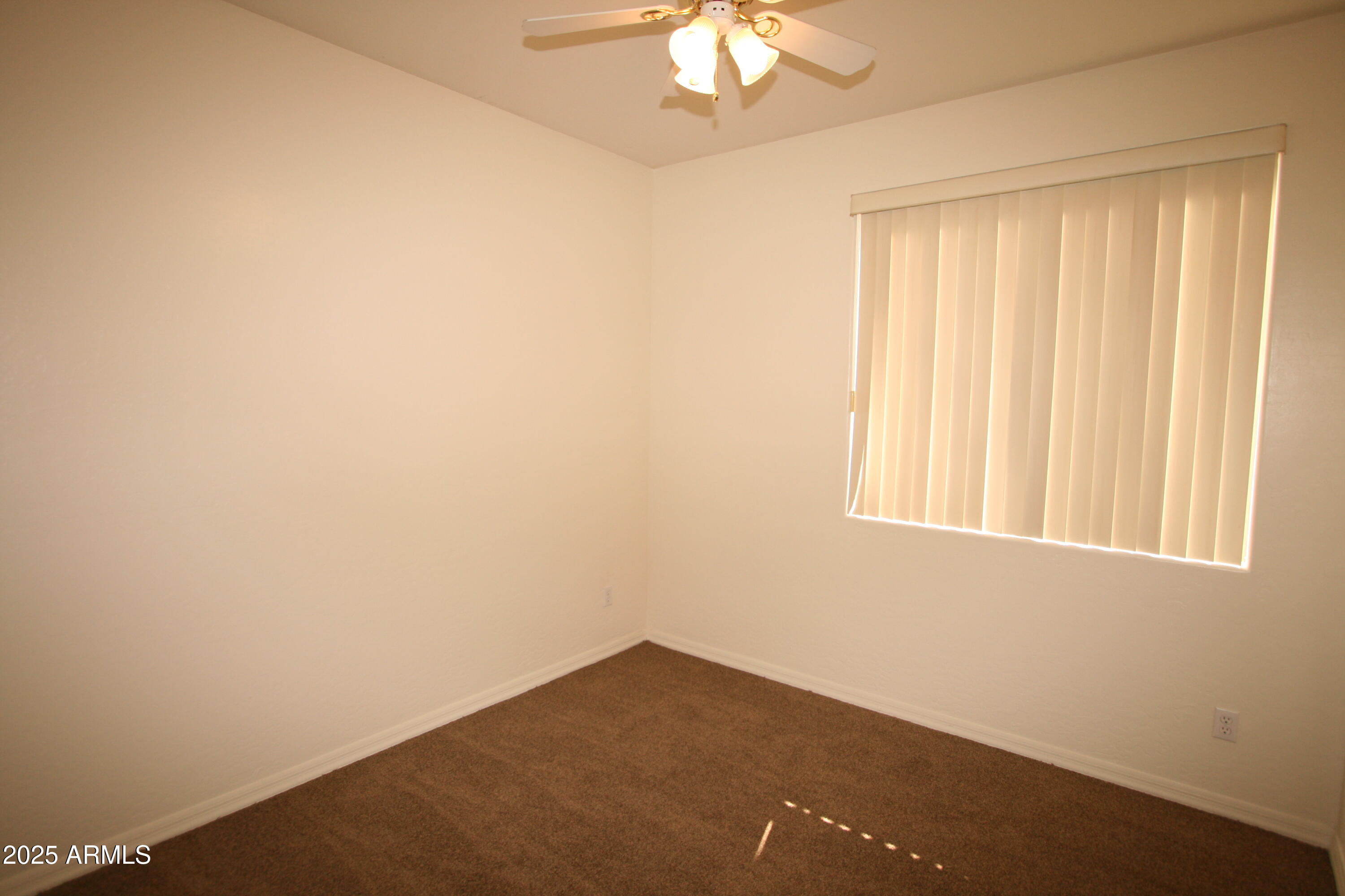 14298 West Verde Lane Goodyear, AZ 85395 - Photo 18 of 21 an empty room with a window