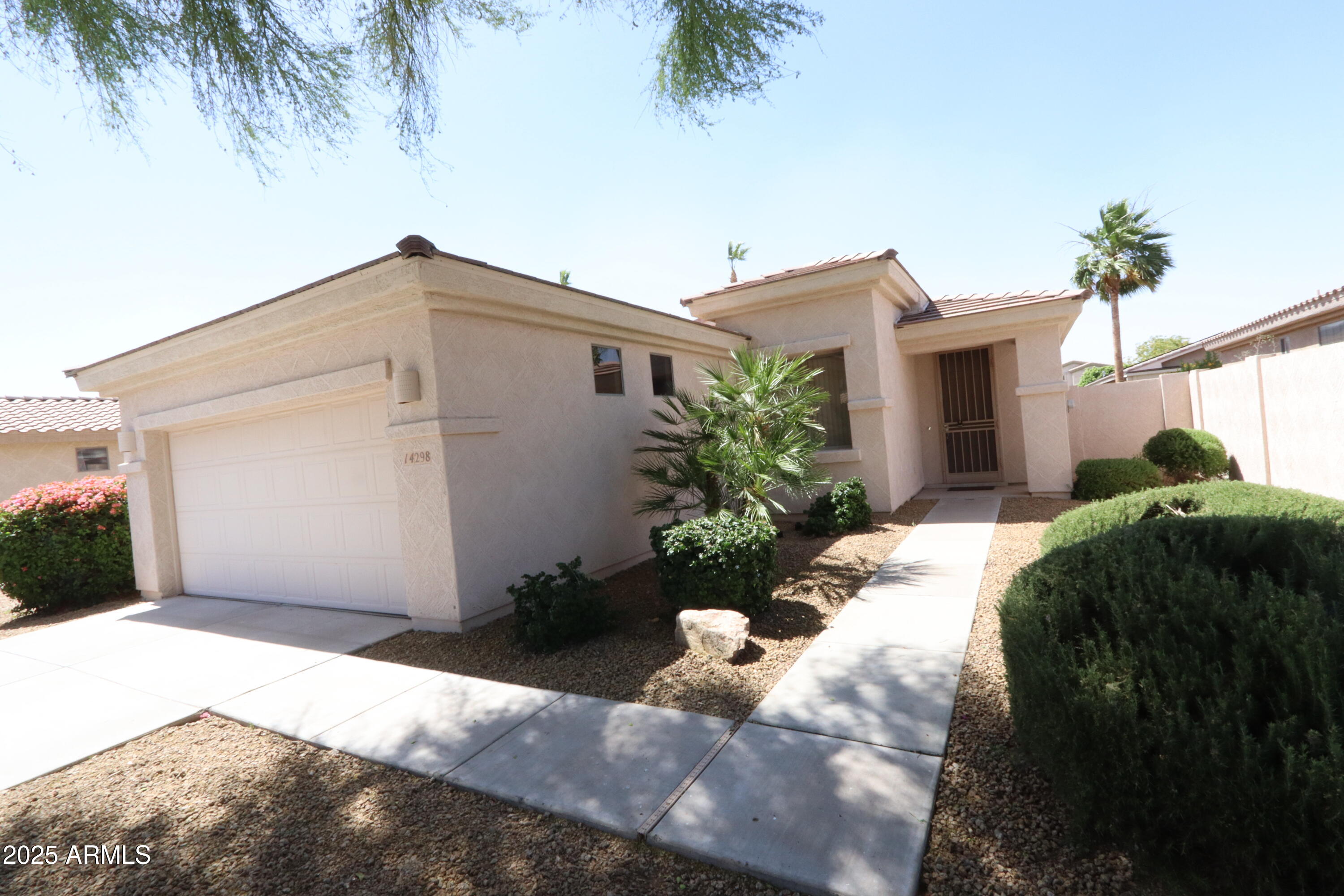 14298 West Verde Lane Goodyear, AZ 85395 - Photo 2 of 21 a house view with a garden space