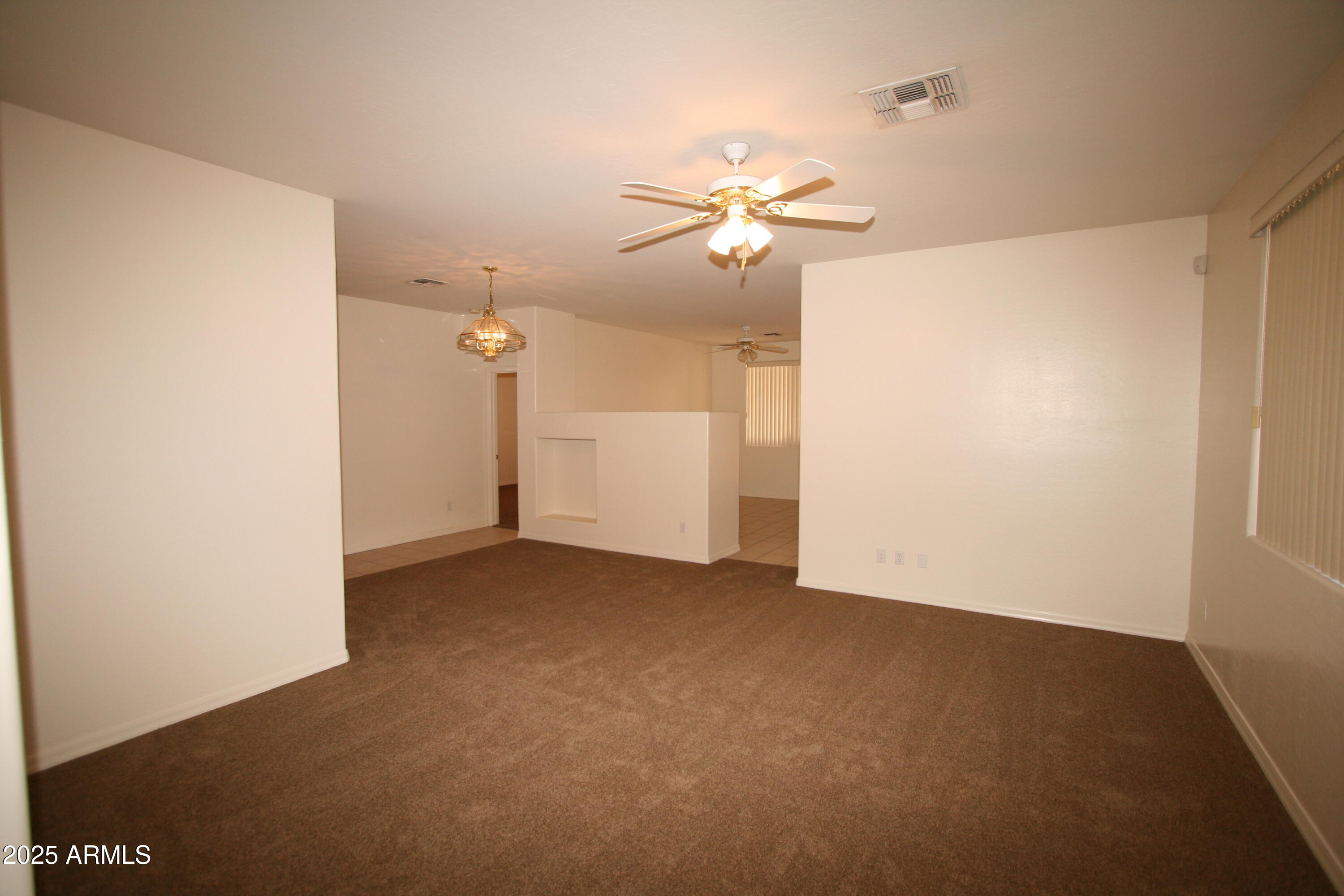 14298 West Verde Lane Goodyear, AZ 85395 - Photo 3 of 21 a view of a big room with carpet