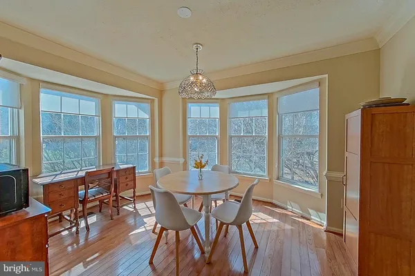 a view of a dining room with furniture large windows and wooden floor