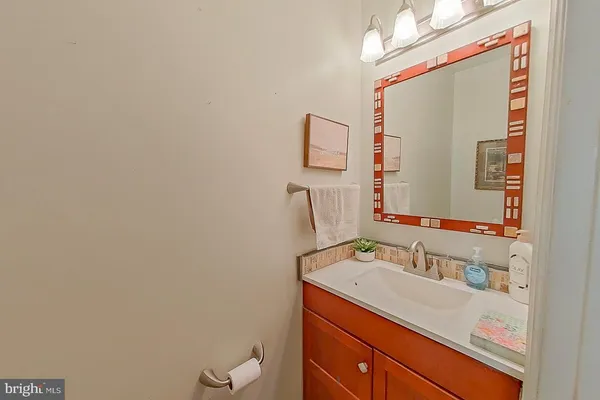 a bathroom with a sink vanity and mirror