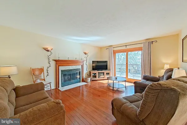 a living room with furniture large window and a fireplace