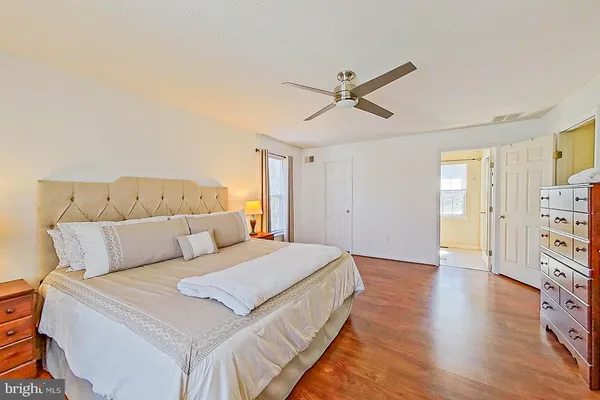 a spacious bedroom with a bed and a flat screen tv