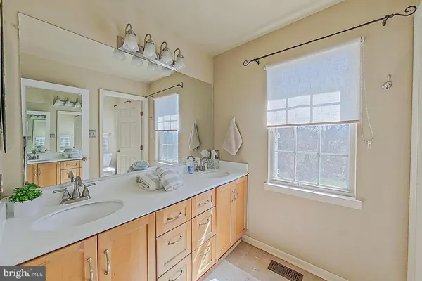 a bathroom with a granite countertop sink mirror and double