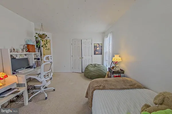 a bedroom with a bed and a desk