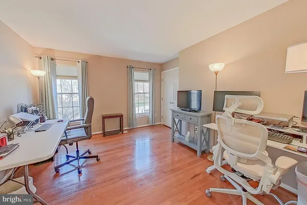 a living room with furniture a flat screen tv and a table