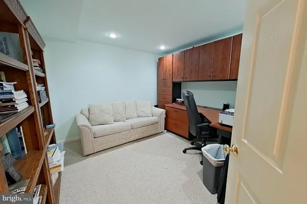 a living room with a couch and a book shelf