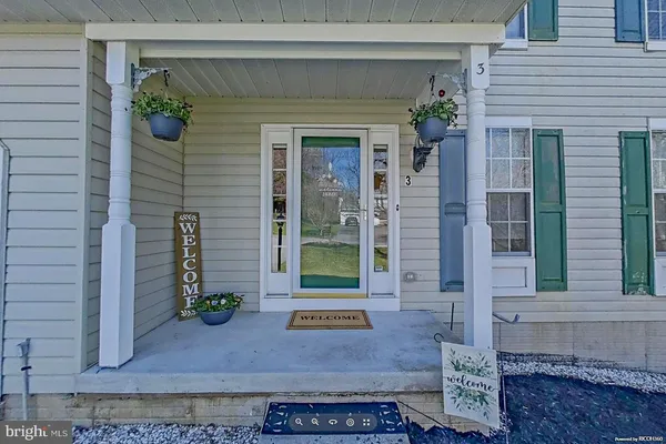 a view of a brick house with potted plants