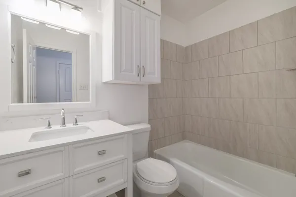 a bathroom with a sink a toilet and bathtub
