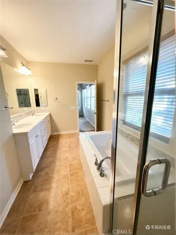 a bathroom with a bathtub sink and mirror