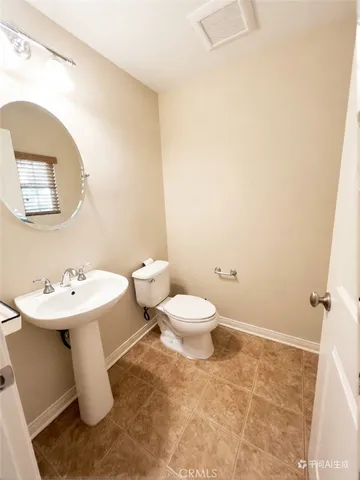 a bathroom with a sink toilet and a mirror