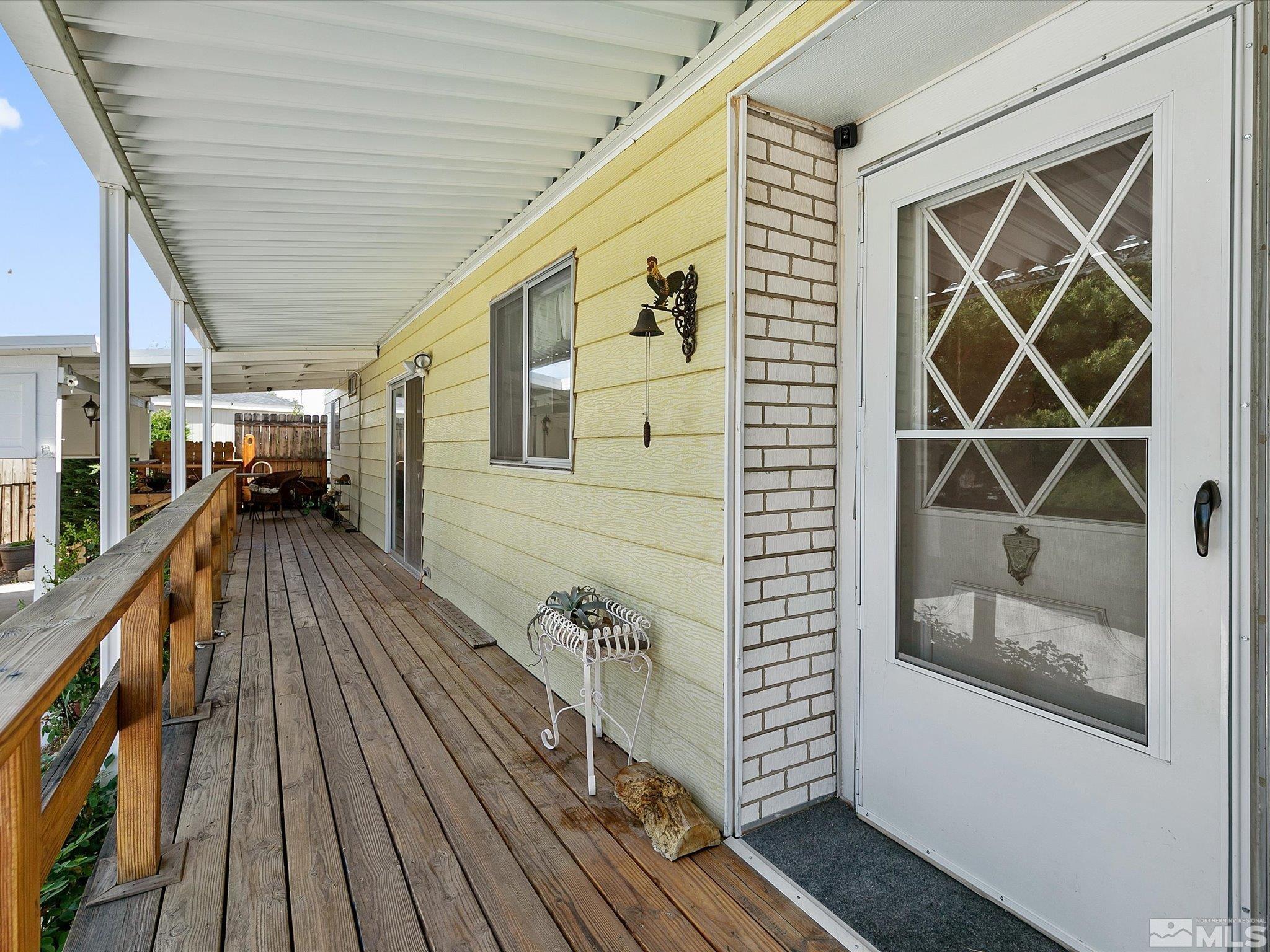 a view of a balcony with wooden floor and potted plants