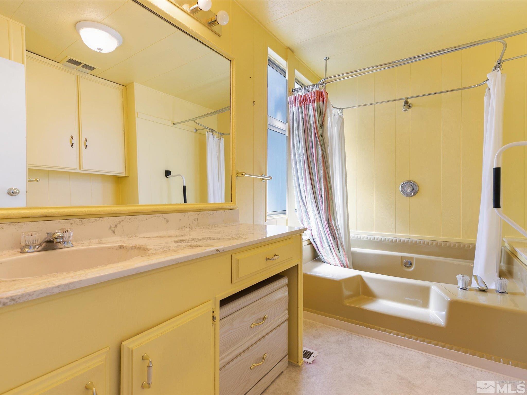 15010 Vega Street Reno, NV 89521 - Photo 20 of 30 a bathroom with a granite countertop sink and a bathtub