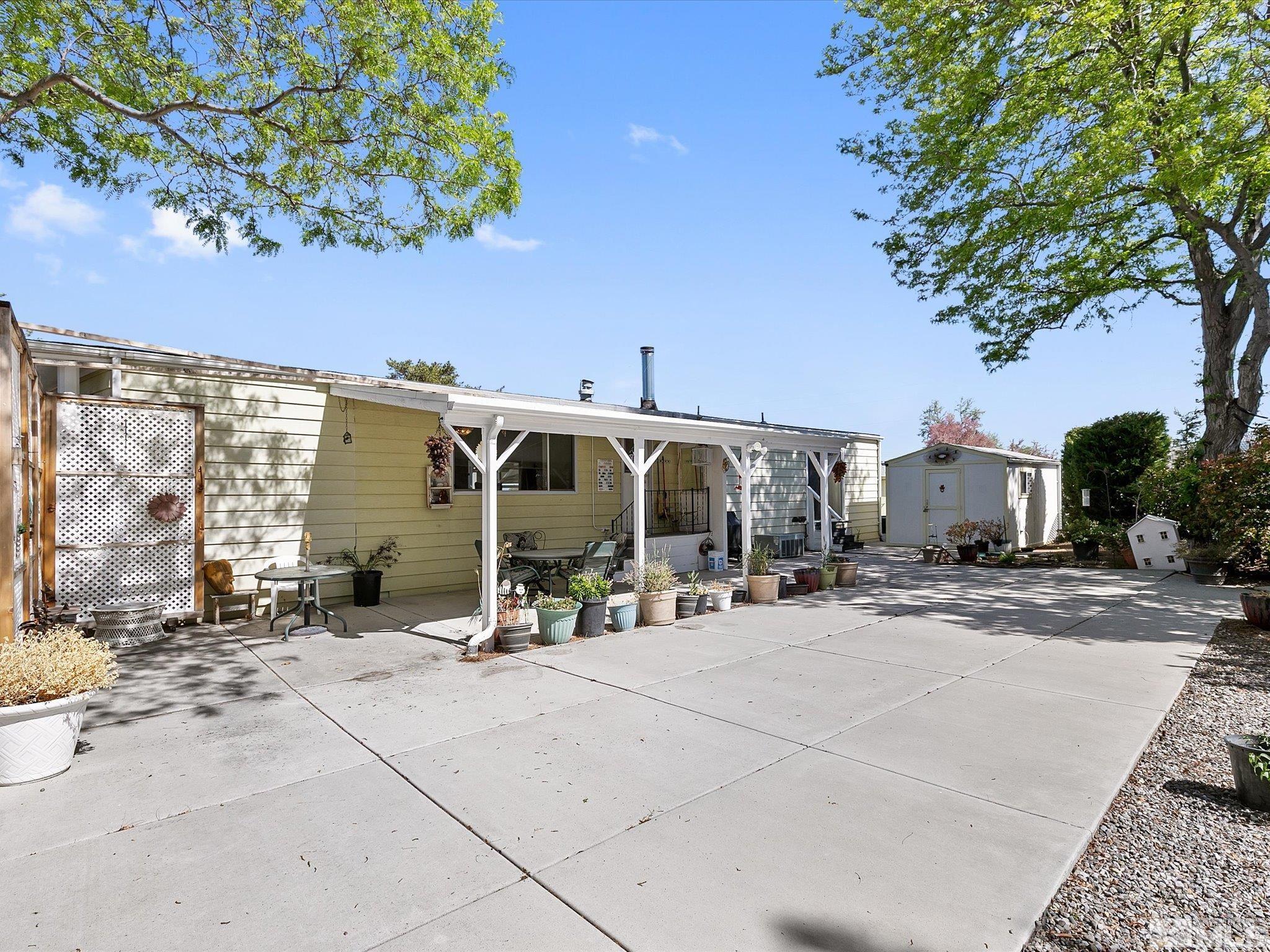 15010 Vega Street Reno, NV 89521 - Photo 26 of 30 a view of a patio with a table and chairs under an umbrella