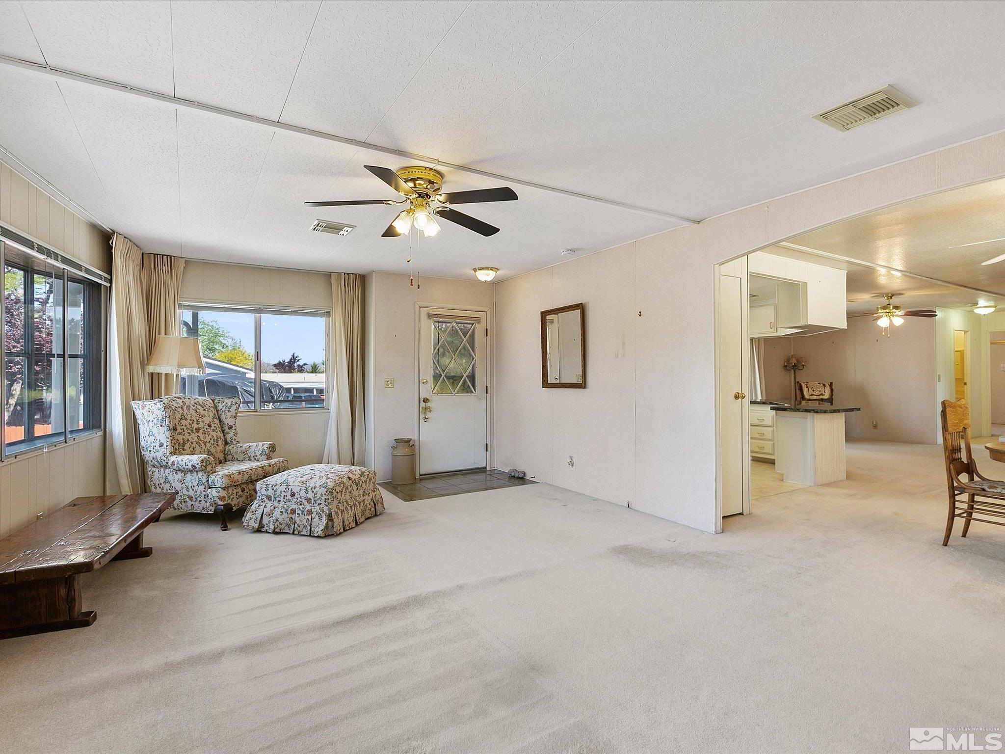 15010 Vega Street Reno, NV 89521 - Photo 8 of 30 a view of a livingroom with a furniture hardwood floor and a ceiling fan