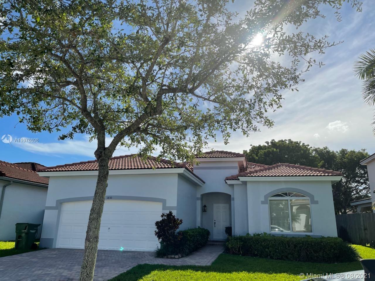 1830 Southeast 20th Road Homestead, FL 33035 - Photo 1 of 6 a front view of a house with garden