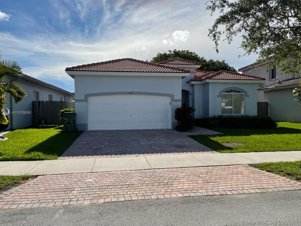 1830 Southeast 20th Road Homestead, FL 33035 - Photo 2 of 6 a front view of a house with a garden