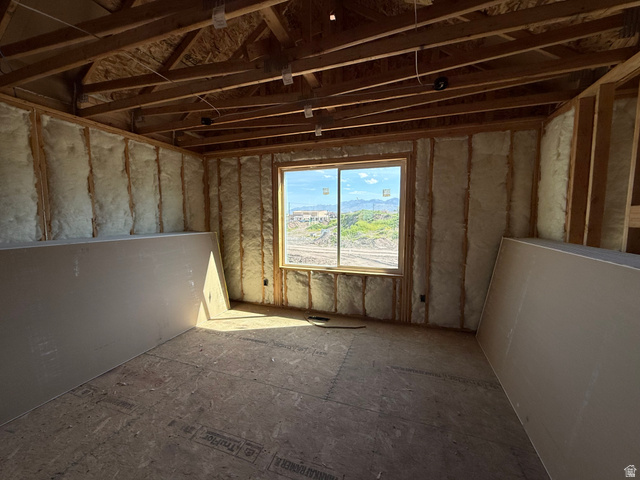 3318 South 1000 West Logan, UT 84321 - Photo 9 of 12 Framed room with visible insulation, exposed ceiling joists, and a double-pane window