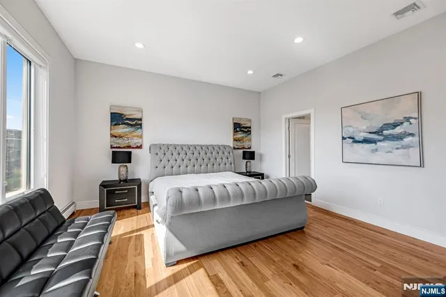 a view of a room with wooden floor and windows