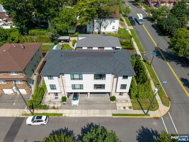 an aerial view of a house with a garden and swimming pool