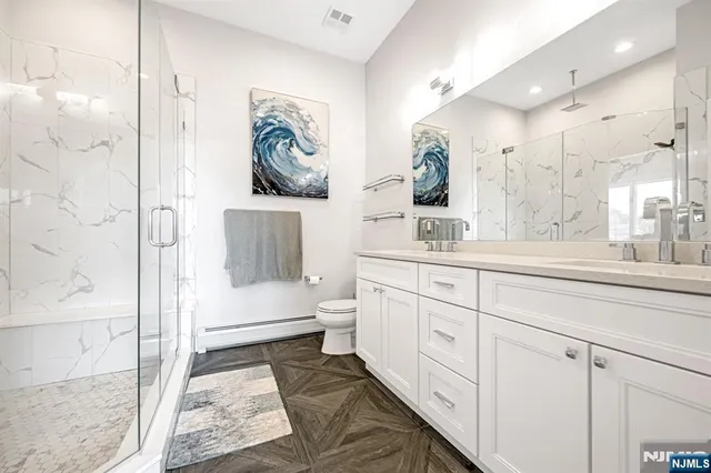 a bedroom with furniture and a wooden floor