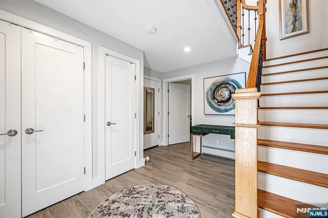 a view of a hallway with wooden floor and a large window