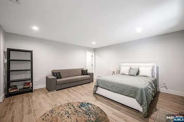 a bedroom with a bed and a couch