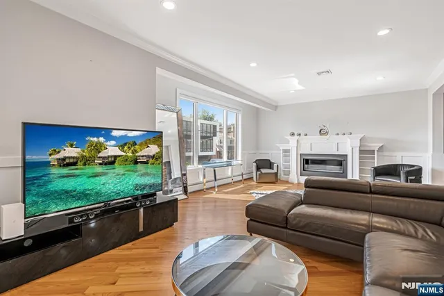 a living room with furniture a fireplace and a flat screen tv