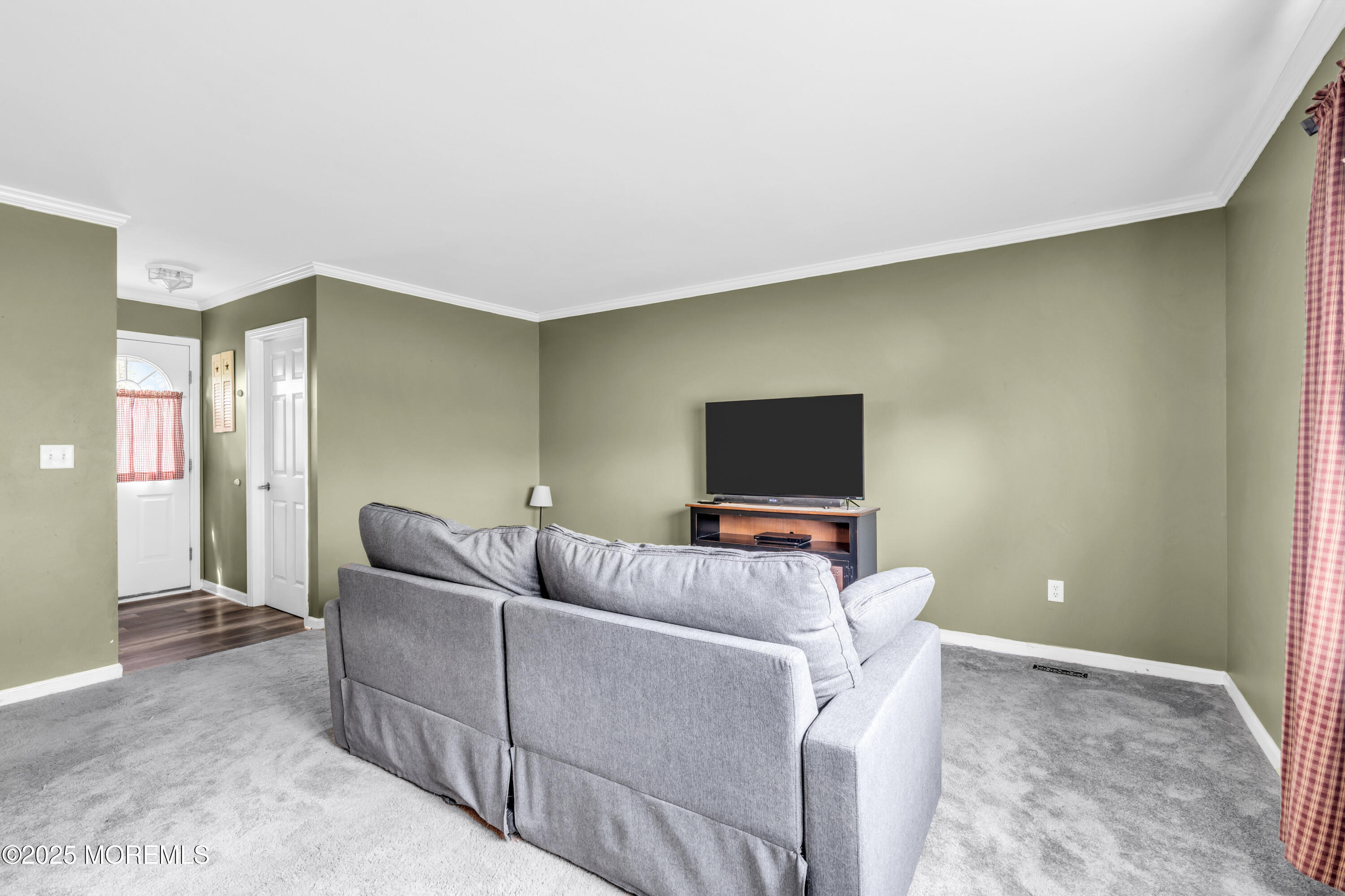 606 E Road Middletown, NJ 07748 - Photo 14 of 28 a living room with furniture and a flat screen tv