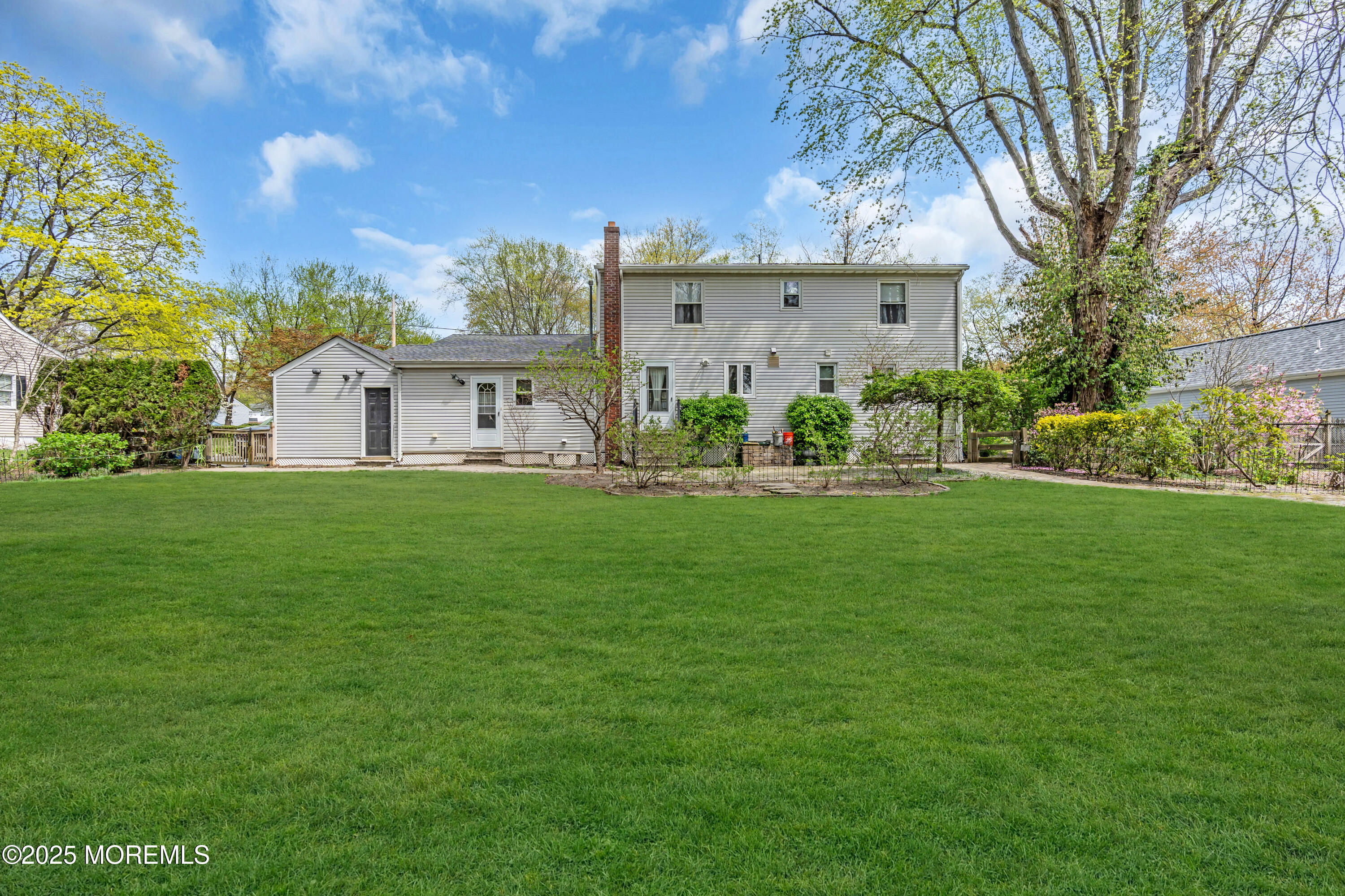 606 E Road Middletown, NJ 07748 - Photo 28 of 28 a front view of a house with garden and trees