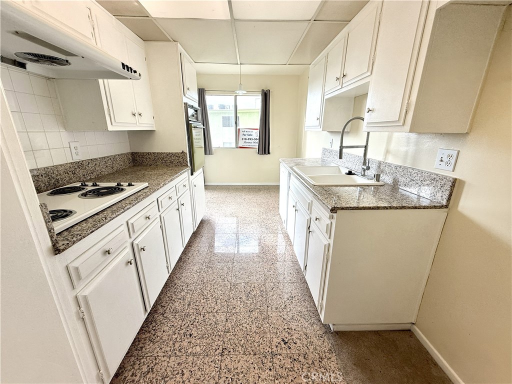1301 South Atlantic Boulevard, Unit 234C Monterey Park, CA 91754 - Photo 11 of 27 a kitchen with sink a stove and cabinets