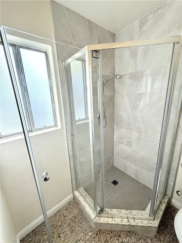 a bathroom with a shower and toilet