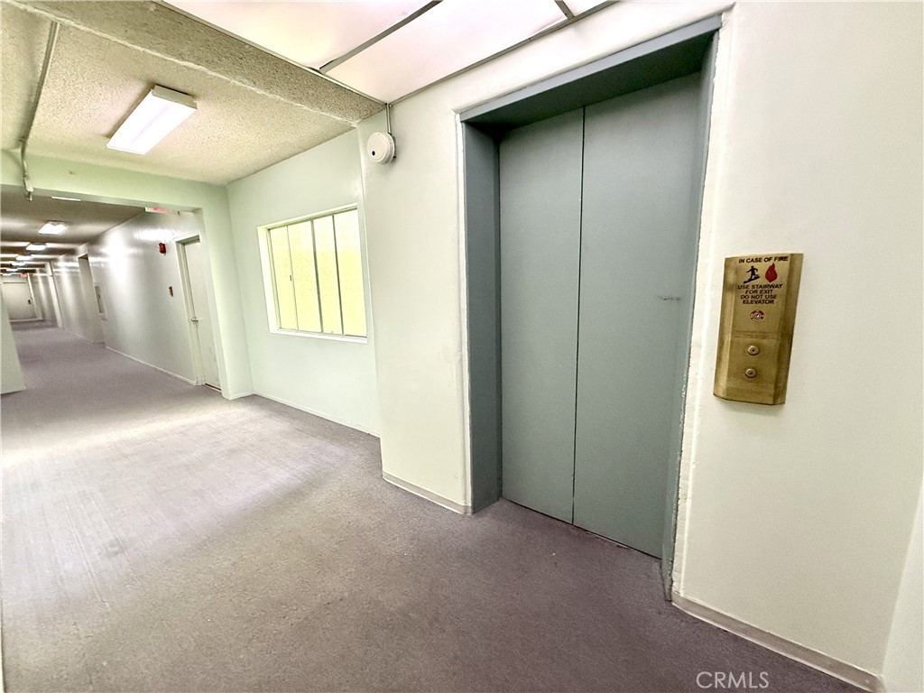 1301 South Atlantic Boulevard, Unit 234C Monterey Park, CA 91754 - Photo 7 of 27 a view of a hallway with wooden shelves