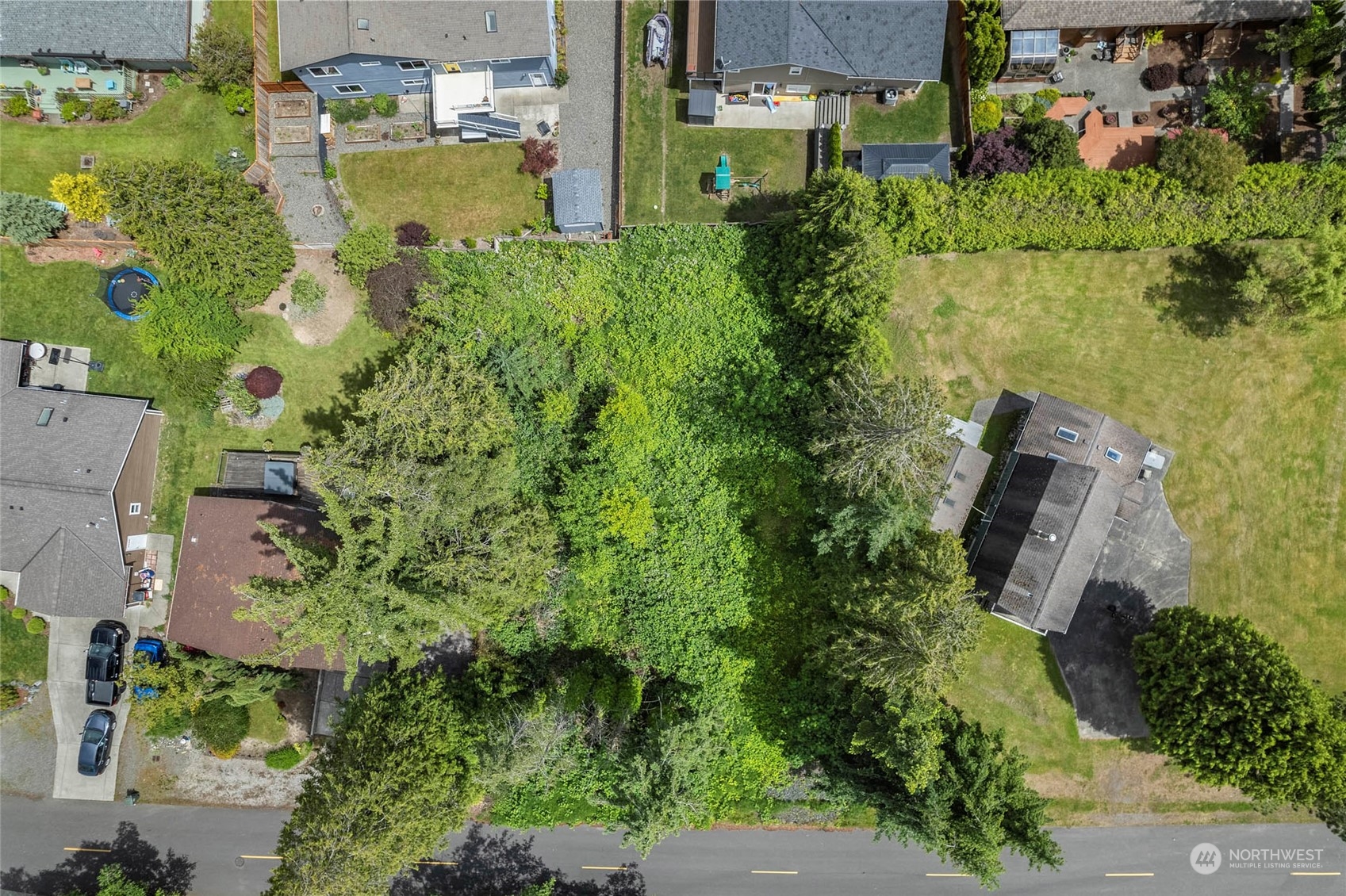 an aerial view of a house with a yard basket ball court and outdoor seating