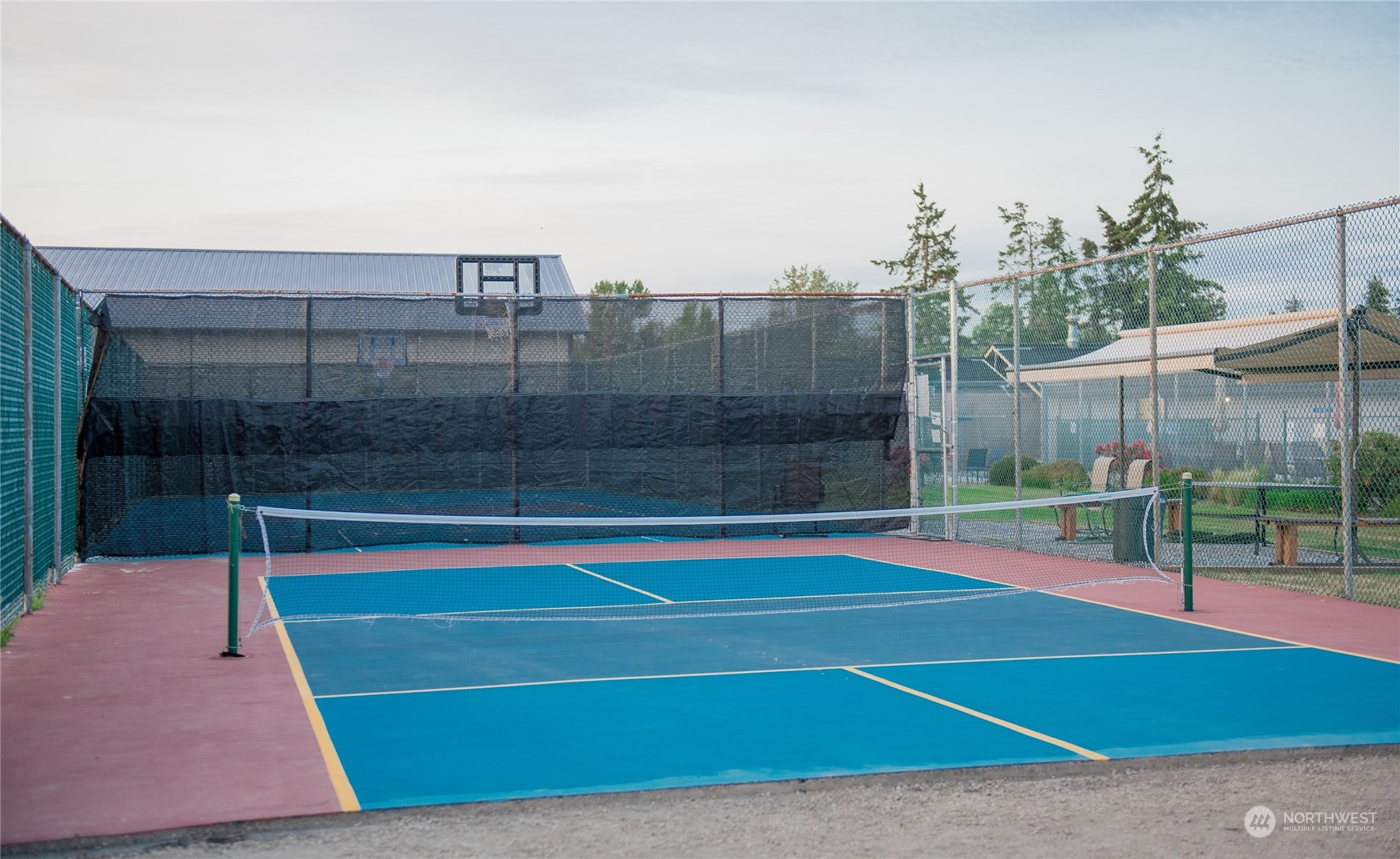 8142 Comox Loop Blaine, WA 98230 - Photo 13 of 17 a view of a tennis court with lots of trees in the background
