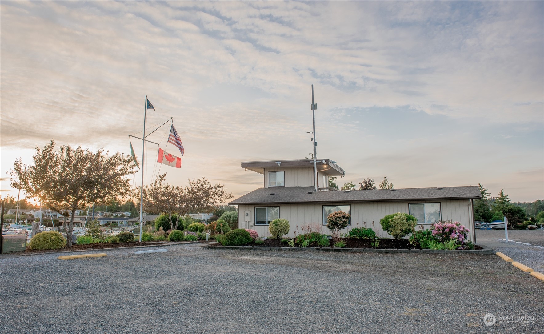 8142 Comox Loop Blaine, WA 98230 - Photo 6 of 17 a view of a house with a garden and large trees