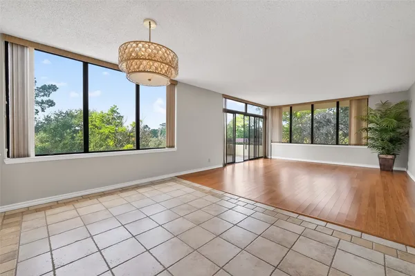 a view of an entryway with floor to ceiling windows and wooden floor
